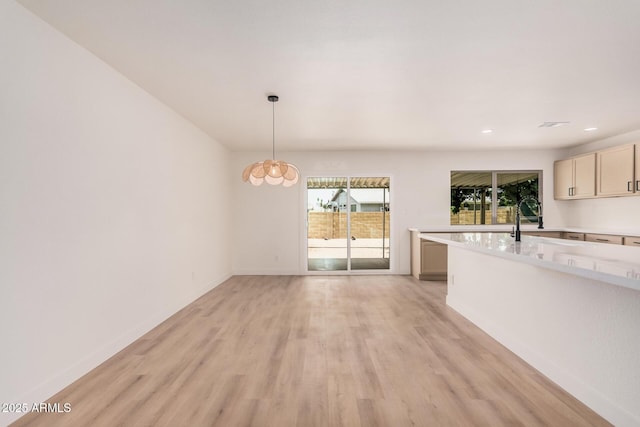 9414 N 50th Dr, Glendale, AZ 85302 - unfurnished living room featuring light wood-type flooring, baseboards, recessed lighting, and a sink