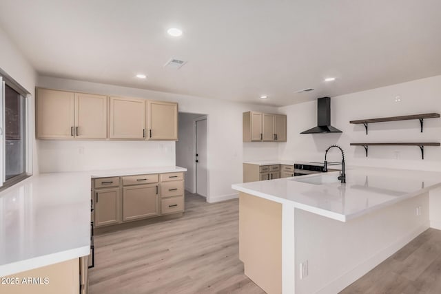 9414 N 50th Dr, Glendale, AZ 85302 - kitchen featuring wall chimney range hood, a peninsula, light wood-type flooring, open shelves, and recessed lighting