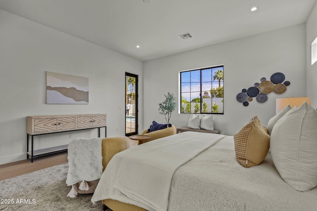 bedroom with visible vents, recessed lighting, baseboards, and wood finished floors