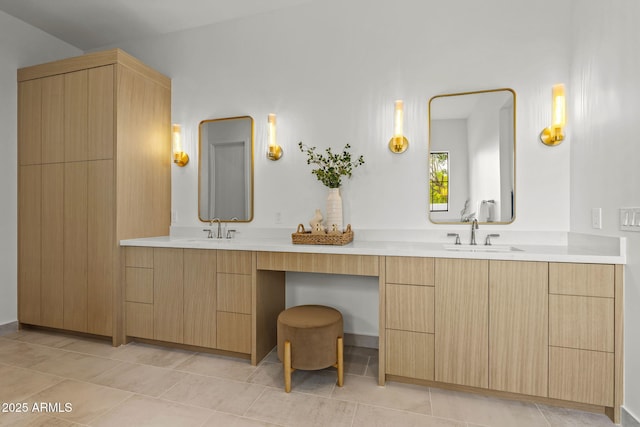 full bath with double vanity, tile patterned floors, and a sink