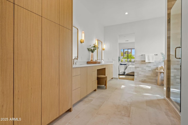 ensuite bathroom with ensuite bathroom, recessed lighting, a stall shower, and vanity