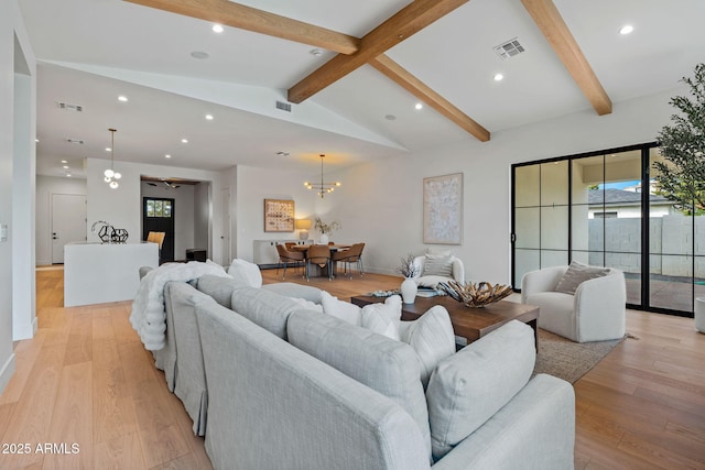 living area featuring a wealth of natural light, vaulted ceiling with beams, recessed lighting, and visible vents