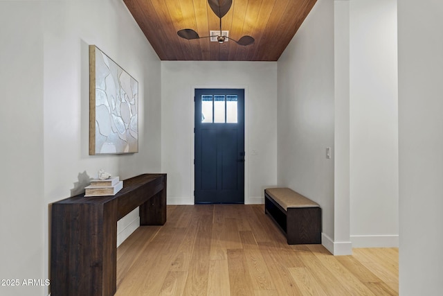entryway with light wood-style floors, baseboards, and wood ceiling