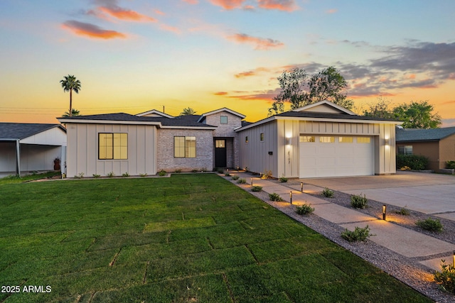 view of front of property with board and batten siding, a garage, concrete driveway, and a front lawn