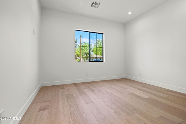 spare room with recessed lighting, baseboards, visible vents, and light wood-type flooring