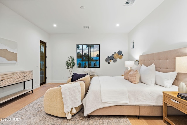 bedroom with recessed lighting, wood finished floors, and visible vents
