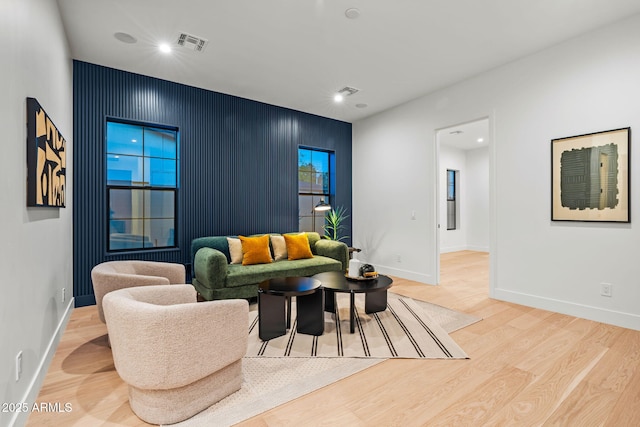 living area with visible vents, recessed lighting, baseboards, and wood finished floors
