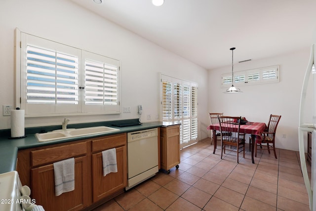 kitchen with dishwasher, light tile patterned floors, pendant lighting, and sink