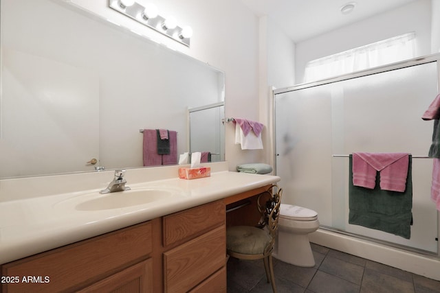 bathroom with toilet, tile patterned flooring, vanity, and walk in shower