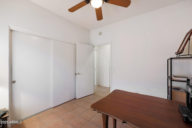 unfurnished office featuring ceiling fan and light tile patterned flooring