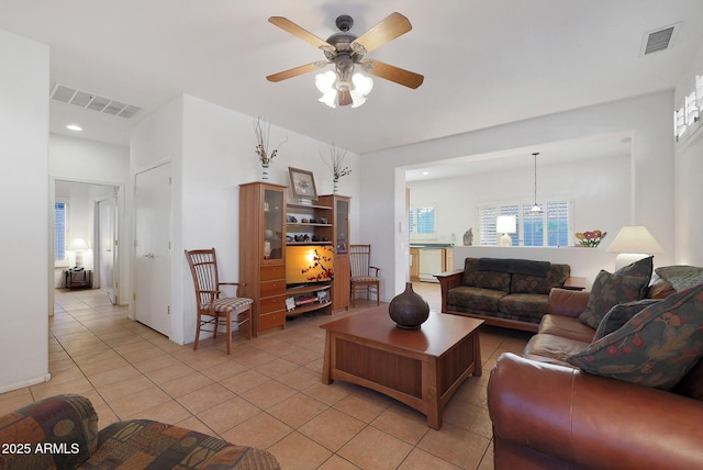 tiled living room with ceiling fan