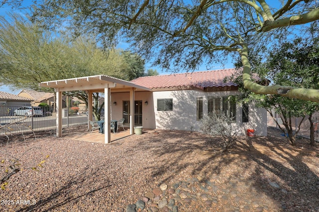 rear view of property featuring a patio