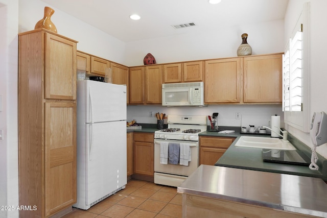 kitchen featuring sink, light tile patterned flooring, and white appliances