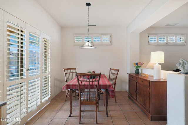 dining area with a wealth of natural light and light tile patterned flooring