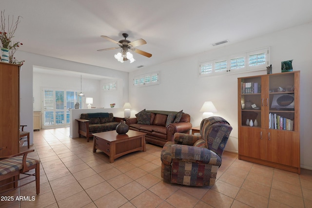 living room with ceiling fan, light tile patterned floors, and a wealth of natural light