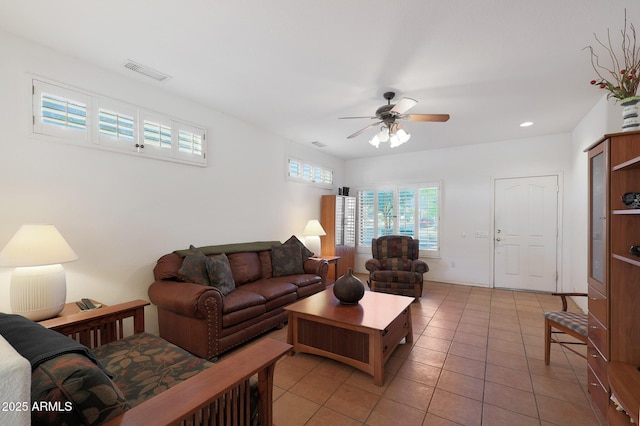 tiled living room featuring ceiling fan