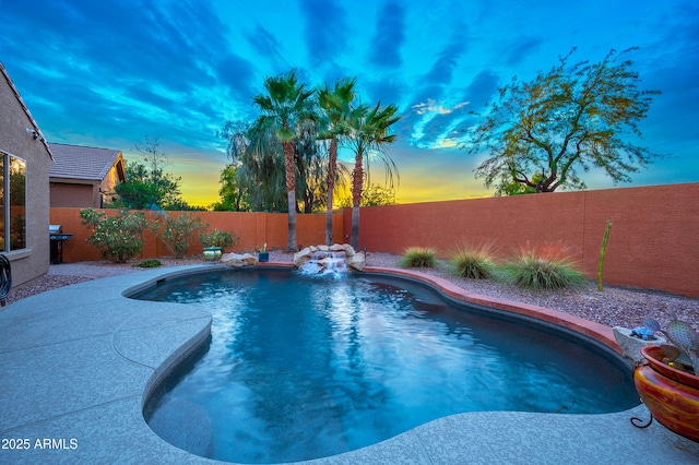 view of pool at dusk