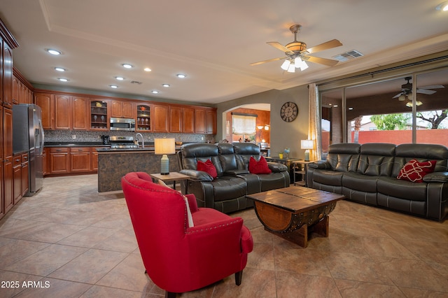 living room featuring sink, ceiling fan, and light tile patterned flooring