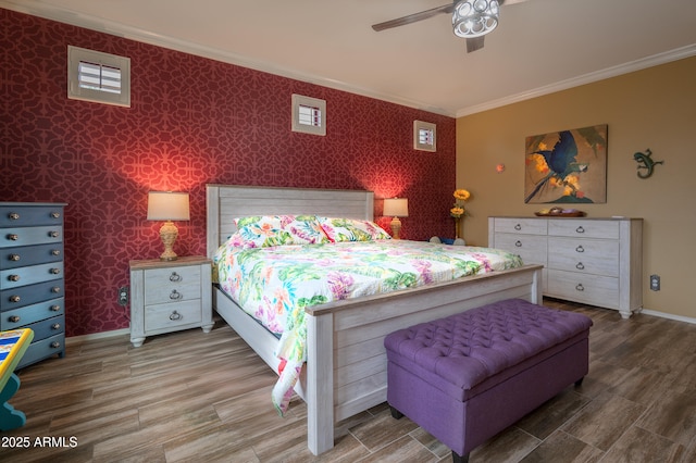 bedroom featuring hardwood / wood-style flooring, ceiling fan, and ornamental molding