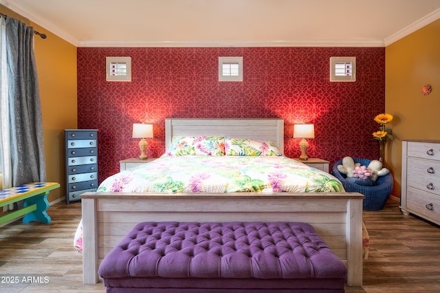 bedroom with crown molding and hardwood / wood-style floors