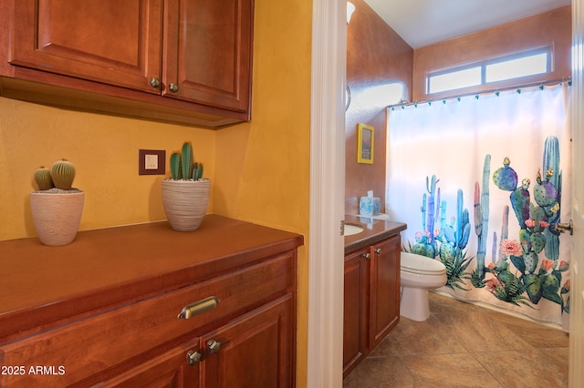 bathroom featuring vanity, walk in shower, and toilet