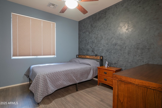 unfurnished bedroom with dark hardwood / wood-style flooring and ceiling fan