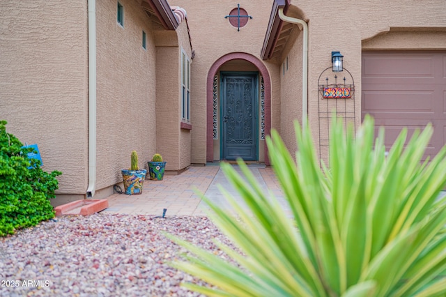 view of exterior entry featuring a garage