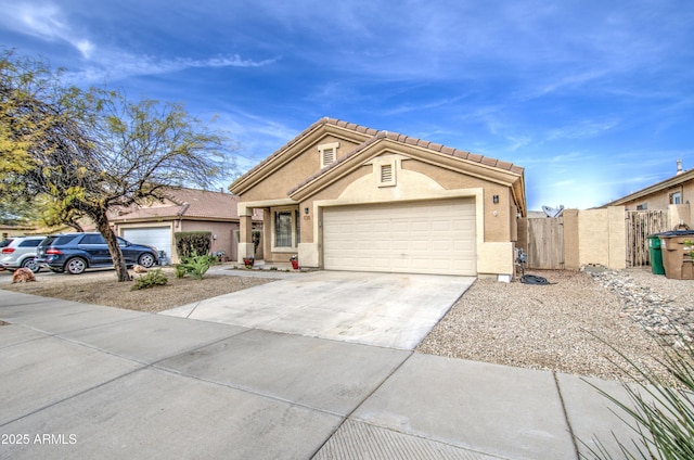 view of front facade featuring a garage, fence, a tile roof, driveway, and stucco siding