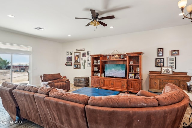 living room with hardwood / wood-style floors and ceiling fan