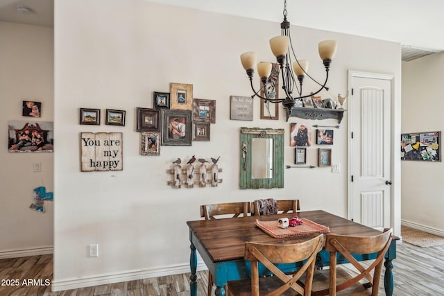 dining room with wood-type flooring and a chandelier