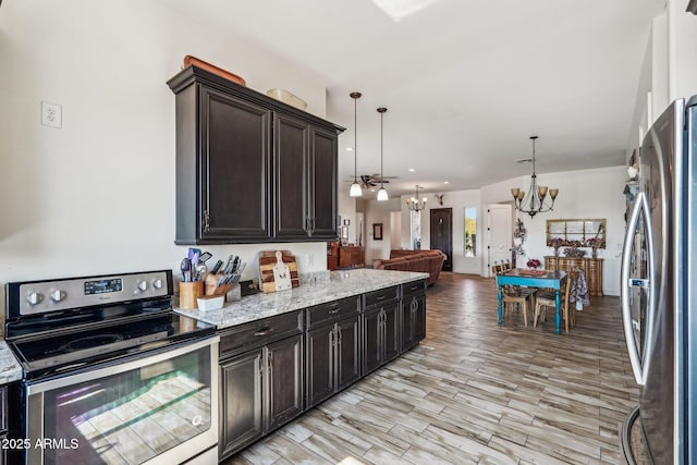 kitchen featuring pendant lighting, stainless steel appliances, a chandelier, and dark brown cabinets