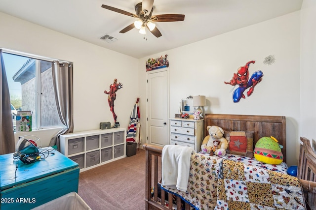 bedroom with ceiling fan and dark carpet