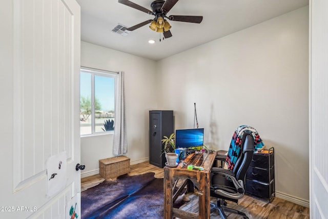 office with wood-type flooring and ceiling fan