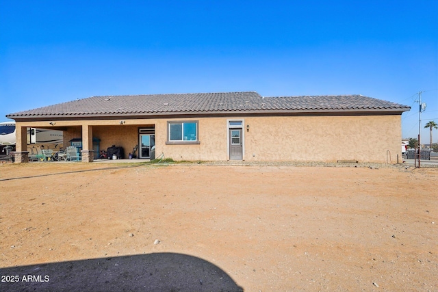 rear view of property featuring a patio area