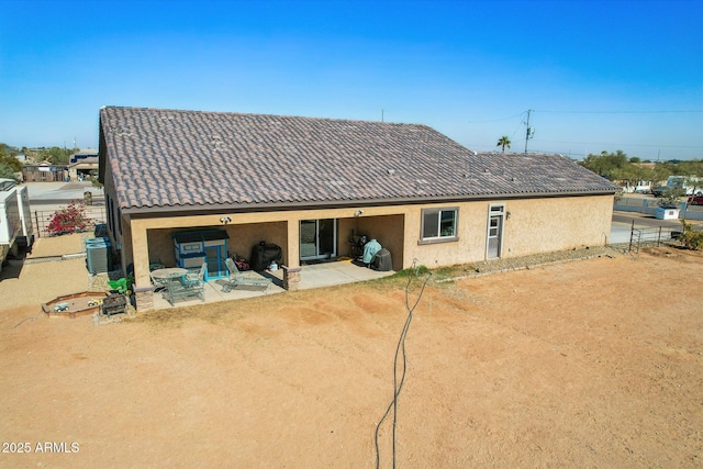 back of property featuring cooling unit and a patio area