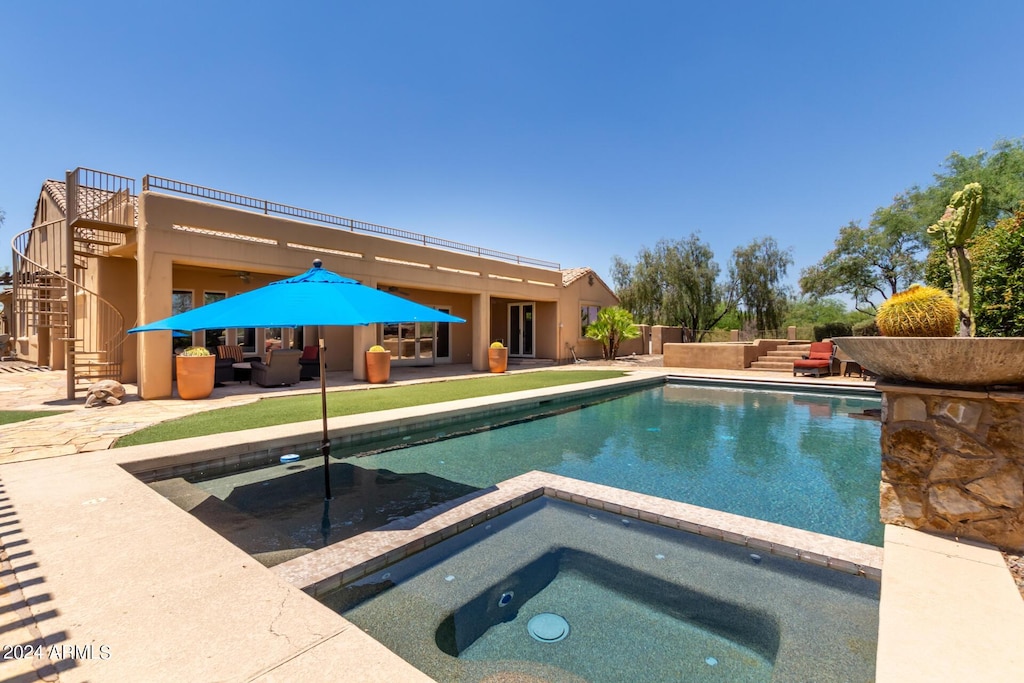 view of pool featuring an in ground hot tub, an outdoor living space, and a patio area