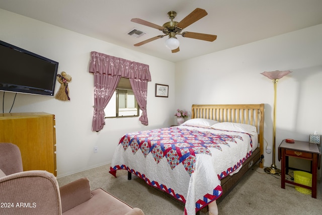 bedroom with ceiling fan and light carpet