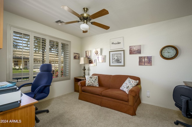 home office with light carpet and ceiling fan