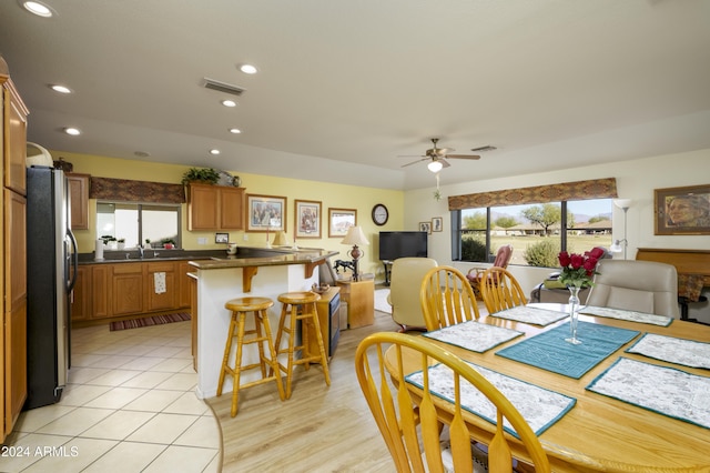 dining area with ceiling fan and sink