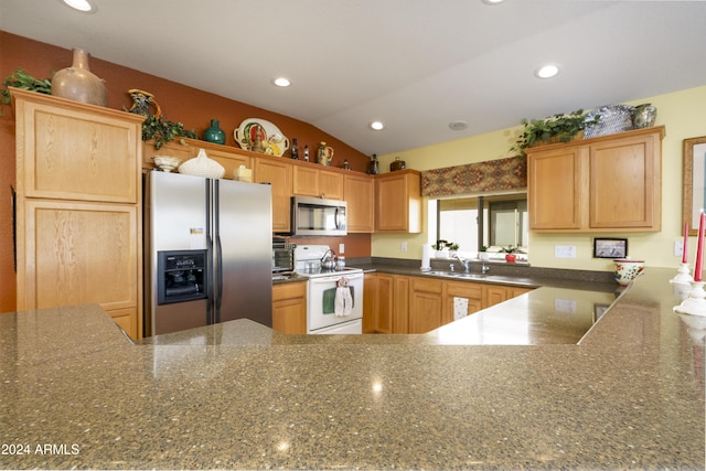 kitchen featuring kitchen peninsula, sink, stainless steel appliances, and vaulted ceiling