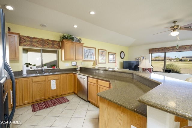 kitchen featuring sink, ceiling fan, light tile patterned floors, appliances with stainless steel finishes, and kitchen peninsula