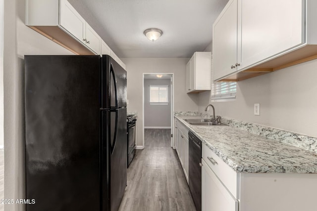 6139 N 31st Dr, Phoenix, AZ 85017 - kitchen featuring light wood-style floors, light countertops, white cabinetry, a sink, and black appliances