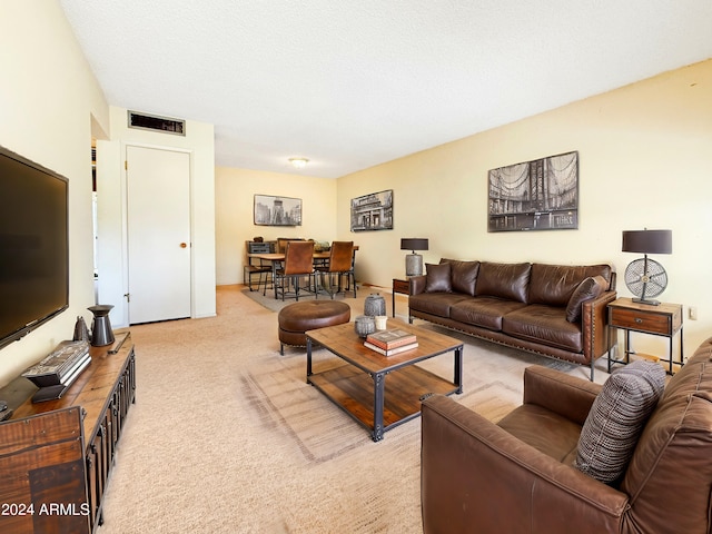 living room with light carpet and a textured ceiling