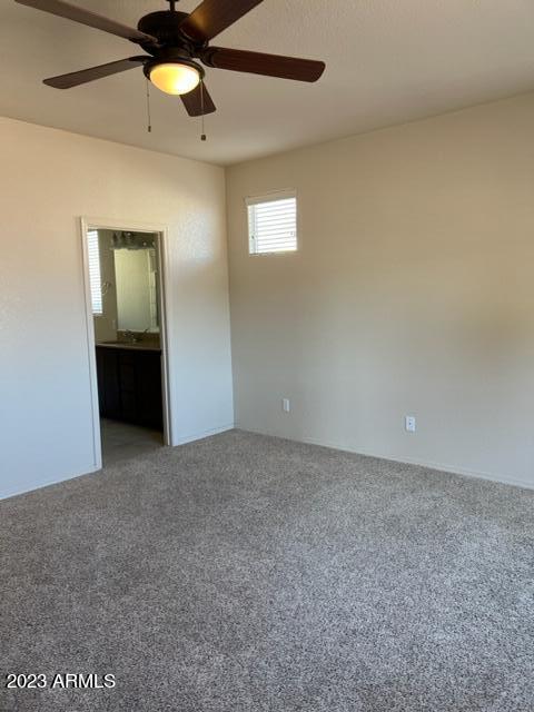 carpeted empty room featuring ceiling fan