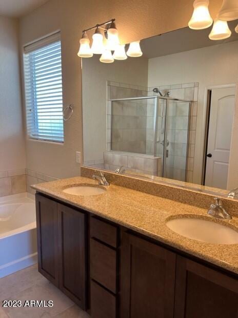 bathroom with tile patterned flooring, vanity, and independent shower and bath