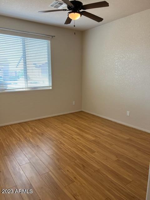 unfurnished room with hardwood / wood-style flooring and ceiling fan