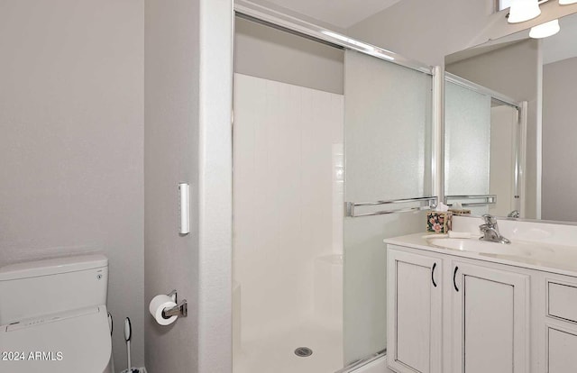 bathroom with vanity, toilet, and an enclosed shower