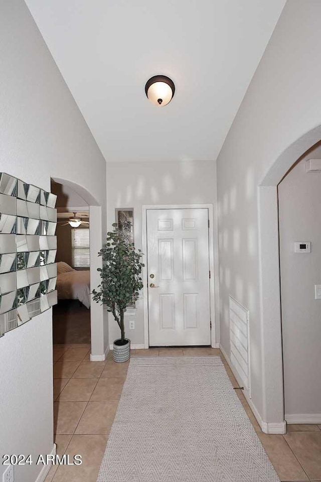 entrance foyer featuring vaulted ceiling and light tile patterned floors