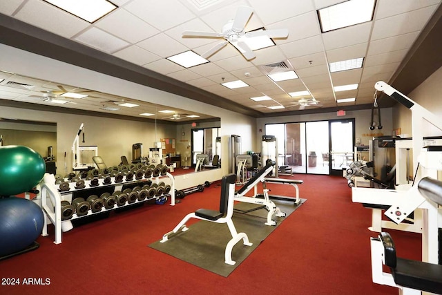 workout area featuring ceiling fan and a drop ceiling