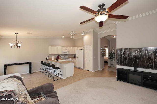 living room with ceiling fan with notable chandelier, ornamental molding, sink, and light tile patterned floors